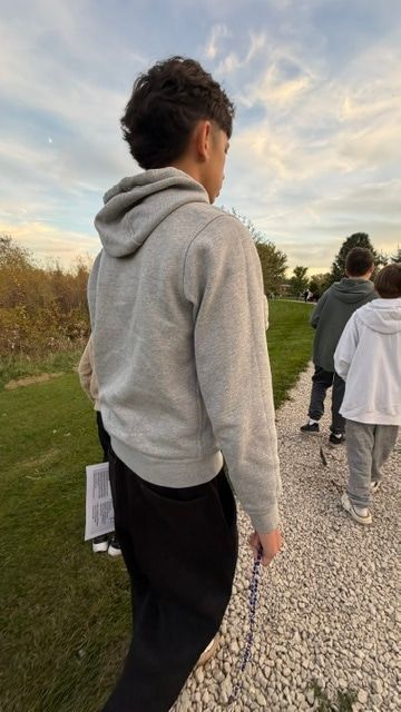 Orion walking with the group, a rosary in his hand.